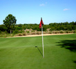 From top to bottom, the elevation on the sixth green at Mystic Dunes Golf Club varies 8 feet. If you aim center or left, you might as well pick up and take your max for the hole.