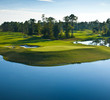 The picturesque finale plays into a peninsula green, the resort and setting sun serving as the backdrop. The green slopes back to front with two distinct landing areas separated by a formidable spine.