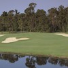 The par-3 sixth hole on the Magnolia Course at Walt Disney World has the signature Mickey Mouse bunker in front of the green.