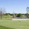 A view of a green with water in background from Lakes at Leesburg (Hometown America)