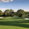 No. 8 at Las Colinas at Mission Inn features a sloping green protected by bunkers on the left and a lake on the right.