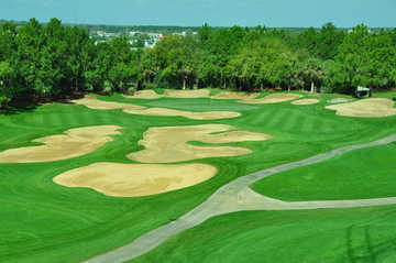 A view of green #14 surrounded by bunkers at Southern Dunes Golf & Country Club